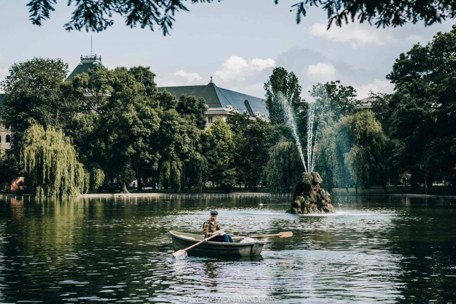 A man rows a paddle boat in Cisimigiu Park, Bucharest