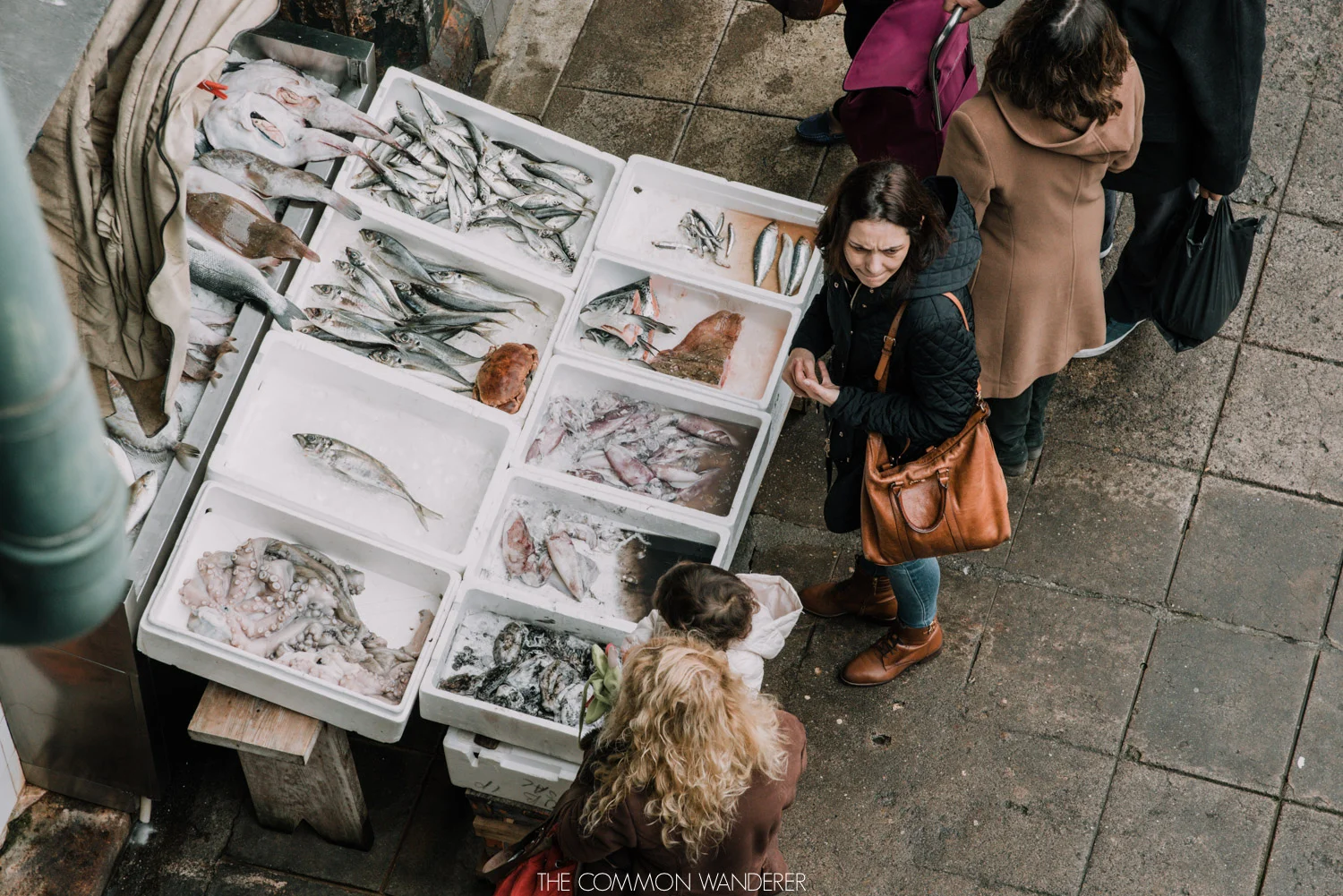 customers line up to purchase fresh seafod in Mercado do Bolhao market, Porto 