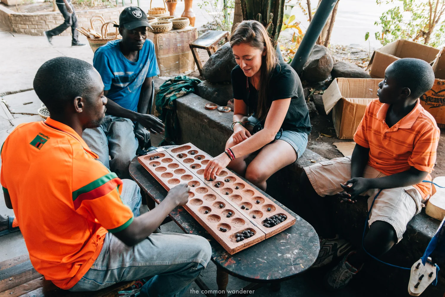 A woman plays Mancala in Livingstone Markets, Zambia - Africa travel tips