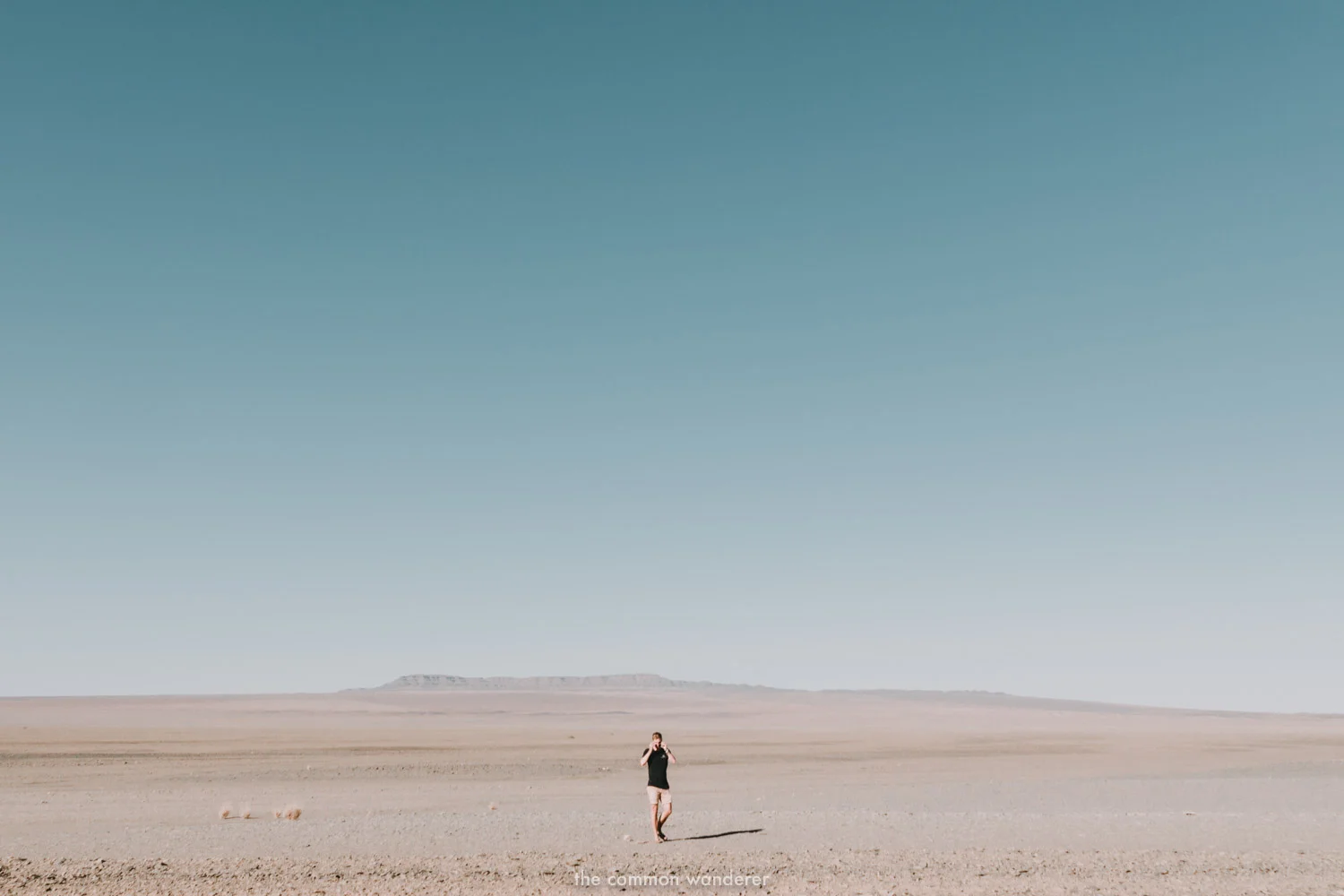 A man walks through the barren plains of Namibia - Namibia photos