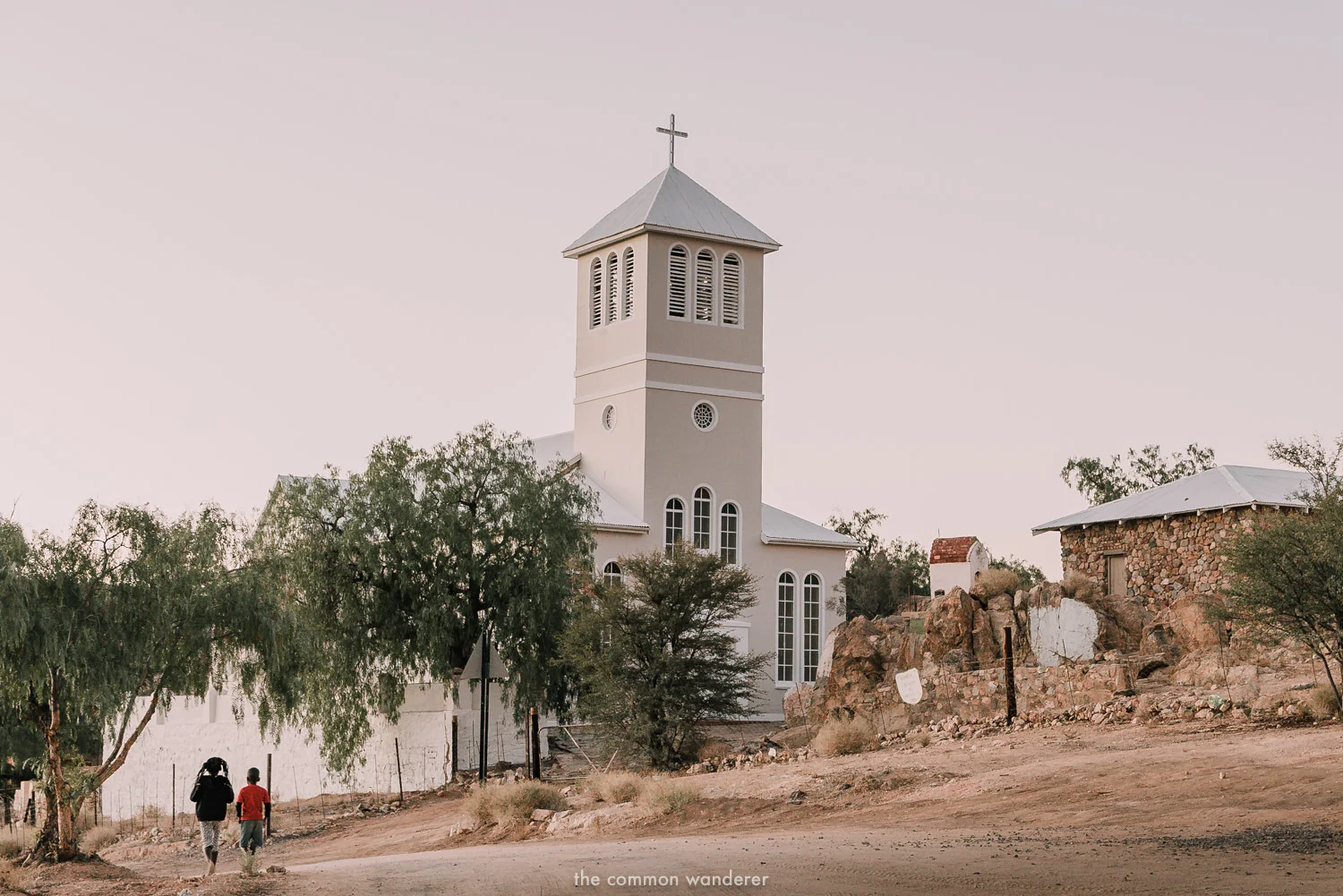 Children walk past Aus church, Aus, Namibia