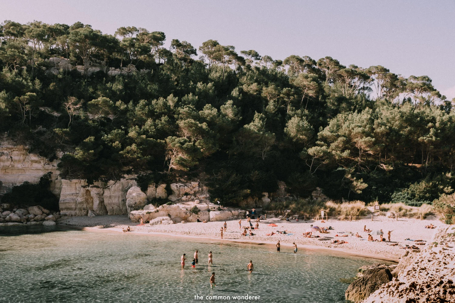 Swimmers frolick at Cala Mitjana, Menorca, Spain