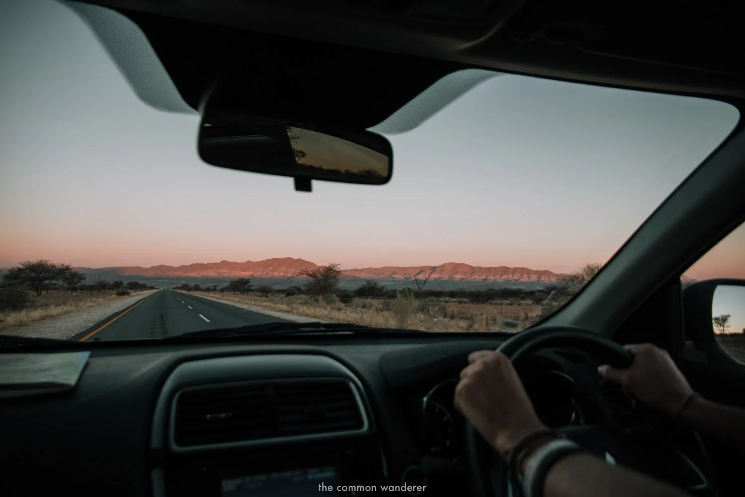 Driving at dusk along a long road in Namibia