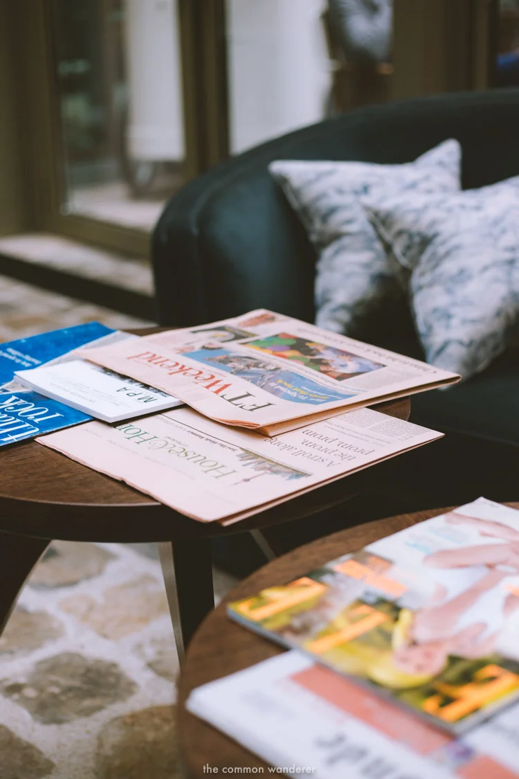 the day's papers rest on a coffee table in the main foyer of the hotel - THECOMMONWANDERER.COM