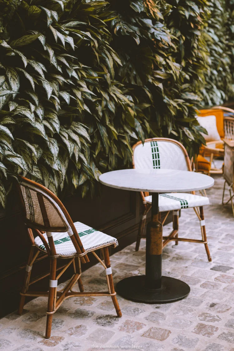 Two smoking chairs and a table sit by the living foliage wall at the hotel - THECOMMONWANDERER.COM