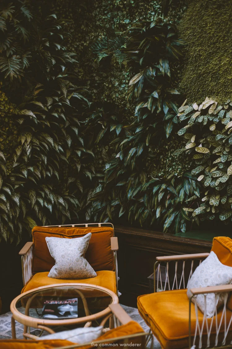 The perfect spot to relax - the lounge chairs by the foliage wall at the Hoxton Paris - THECOMMONWANDERER.COM