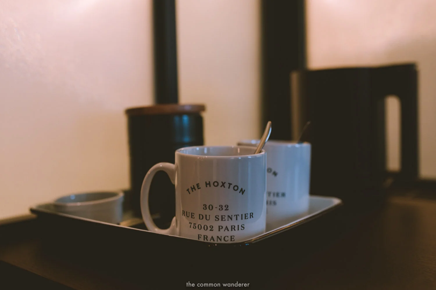 Beautifully designed mugs with the Hoxton Paris printed on them in the tea section of the interior. - THECOMMONWANDERER.COM