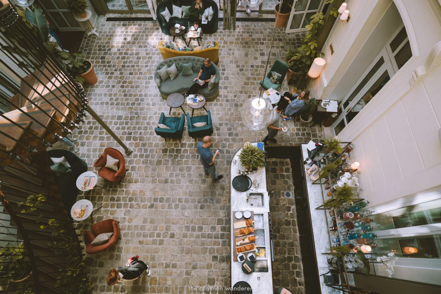 The Hoxton Paris' grand entrance, complete with cobblestoned floors, glass and steel structures, and plush furniture. The cafe serves pastries and brilliant coffee all day too! - THECOMMONWANDERER.COM