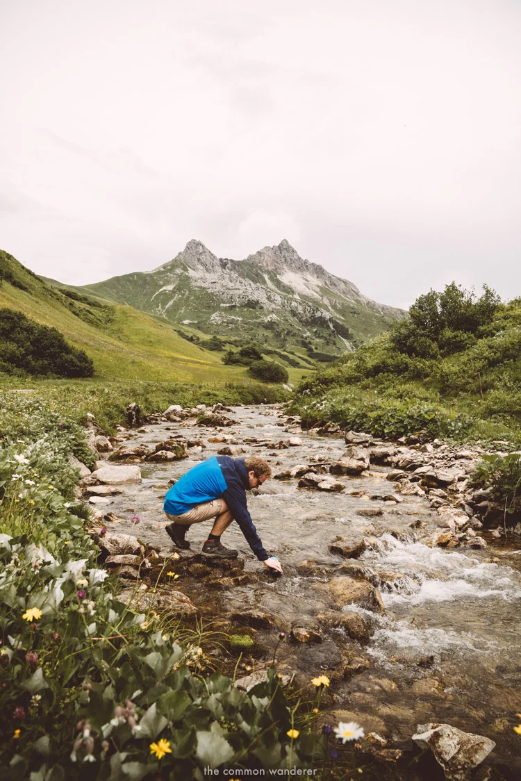 Filling up a water to go bottle in one of the mountain streams in Austria