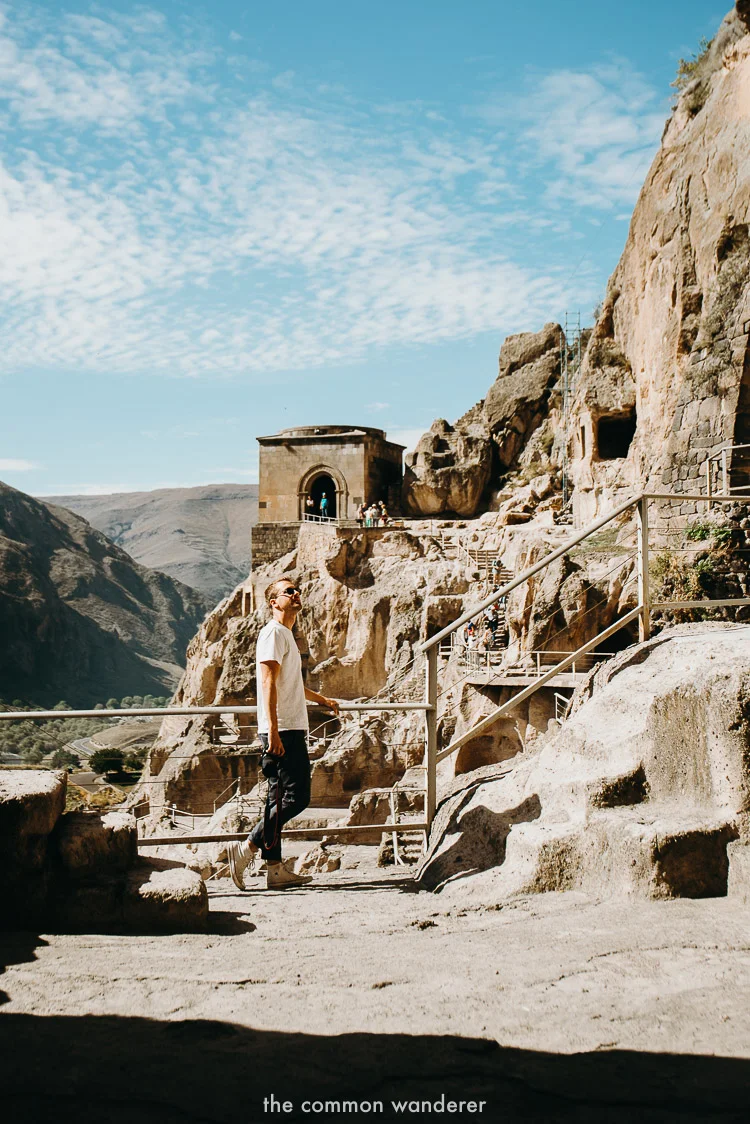 A man stands at Vardzia caves in Georgia