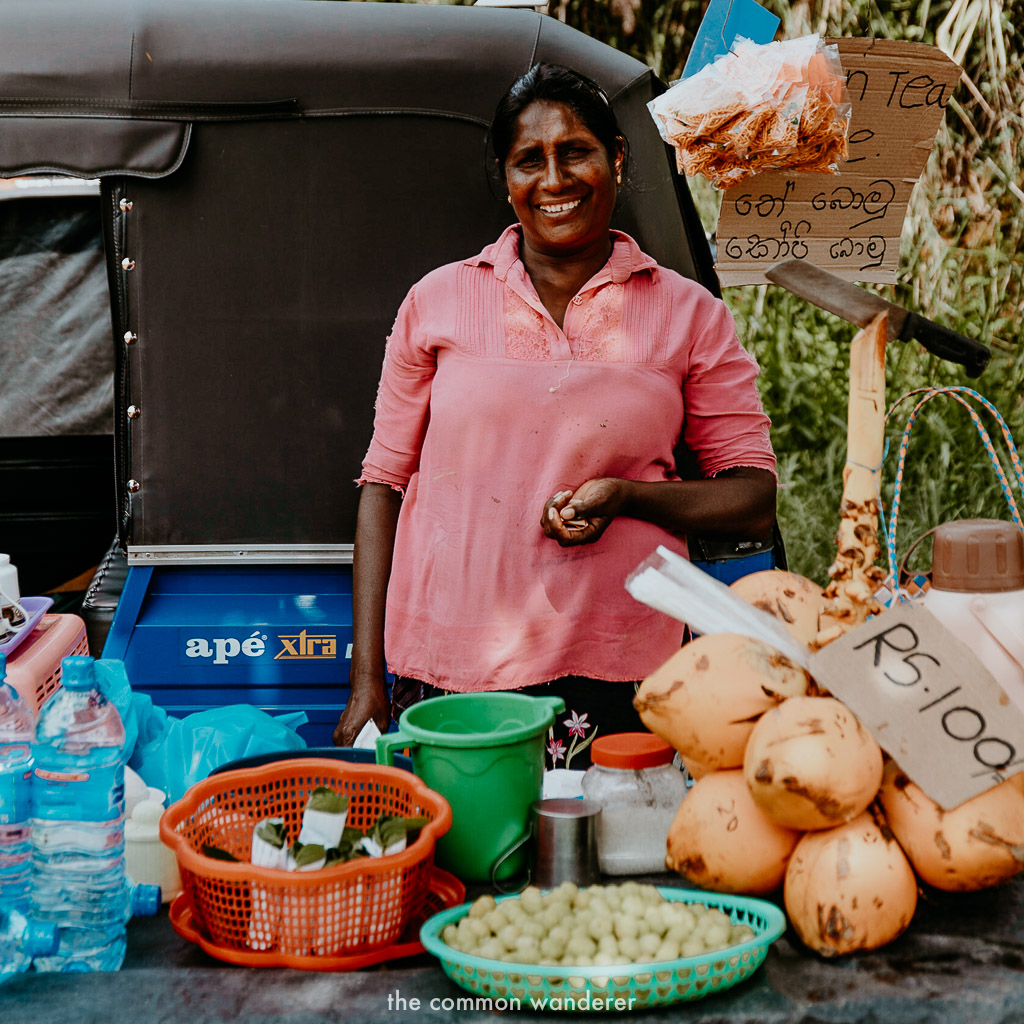 A women sells goods on the side of the road in Sri Lanka