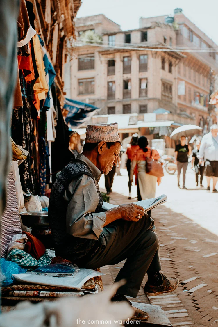 A man reads a newspaper in Bhaktapur old town, Kathmandu