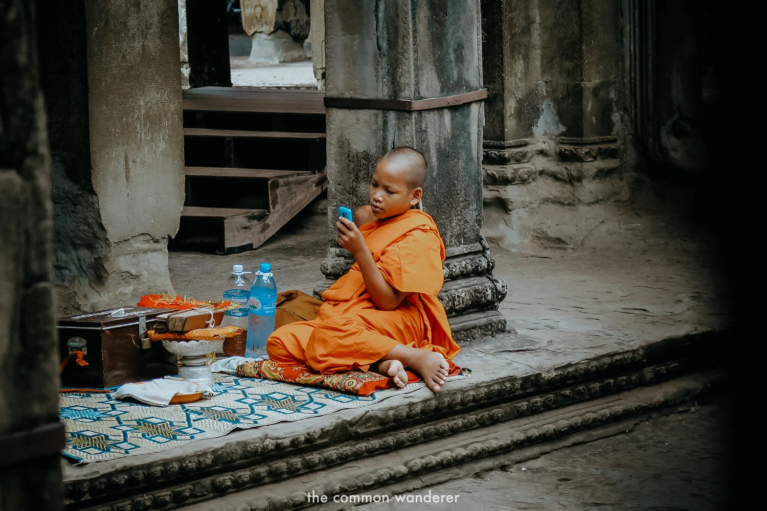 A monk on his phone in Angkor Wat, Cambodia
