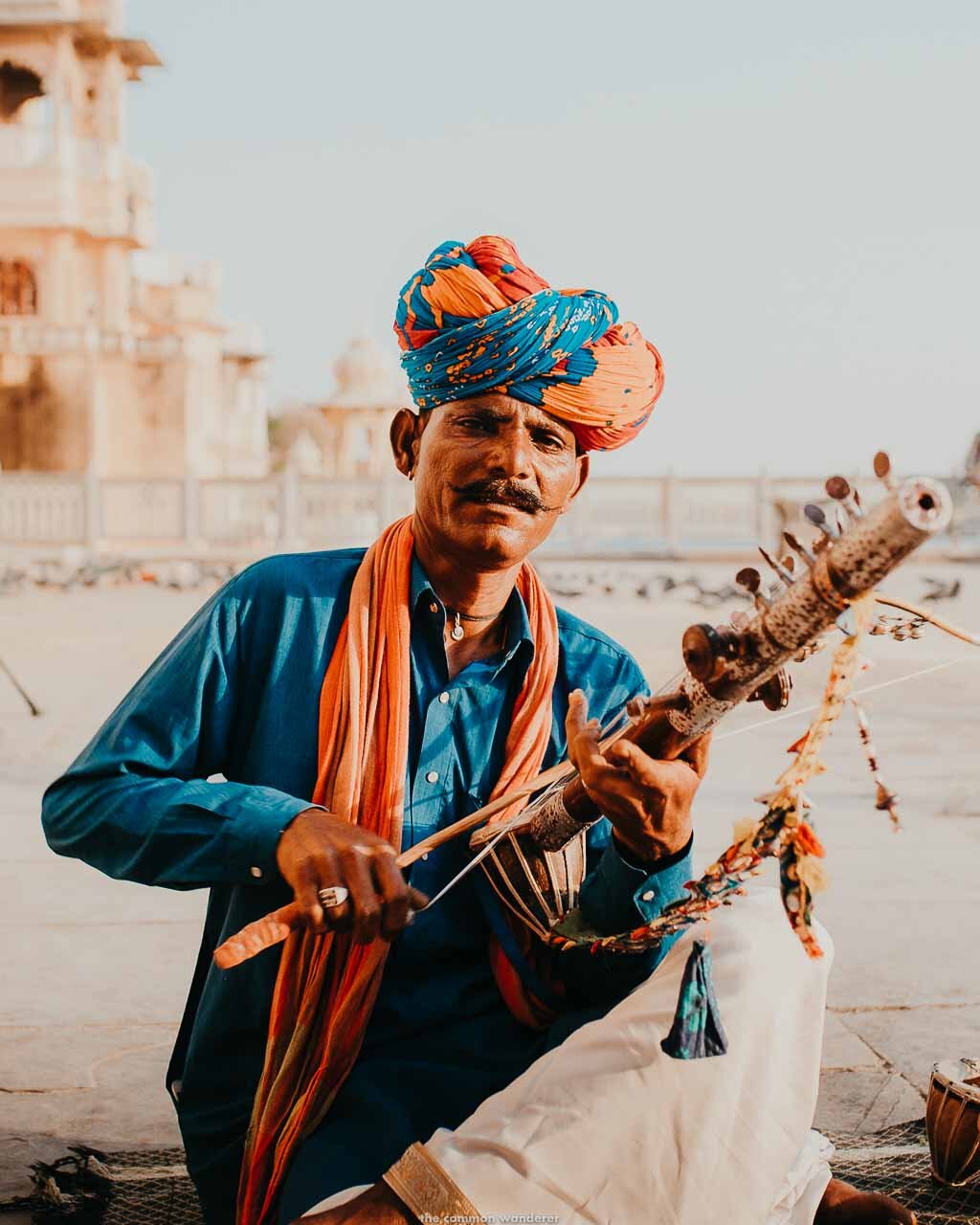 A portrait of a local Indian man playing a sarangi on Gangaur Ghat, Udaipur