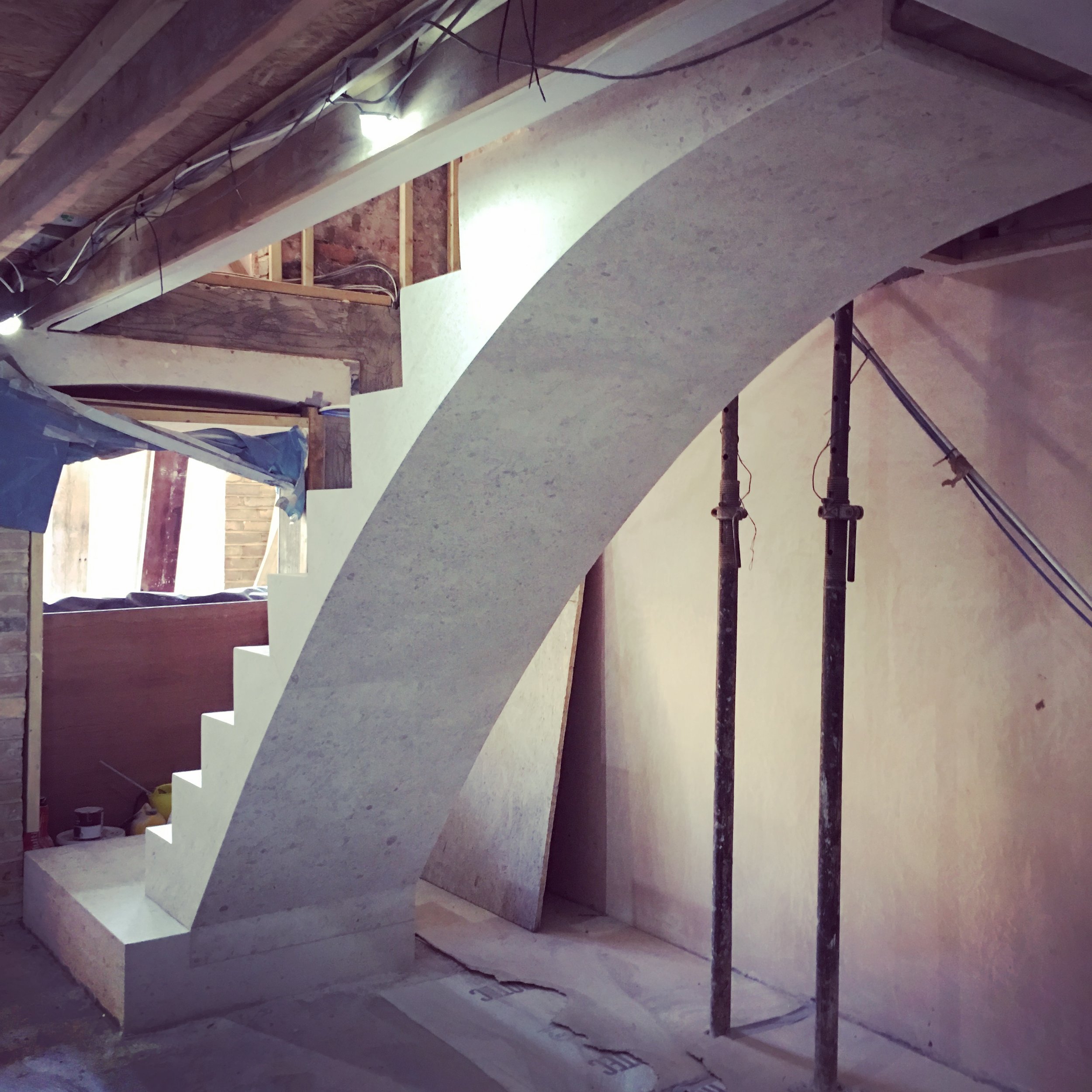 Three pieces of Mirabelle limestone create a simple structural arch spanning the length of the stair.