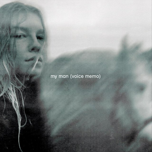 A woman with wet hair and a brooding expression, sitting with a dog, with the text "my man (voice memo)" overlayed.
