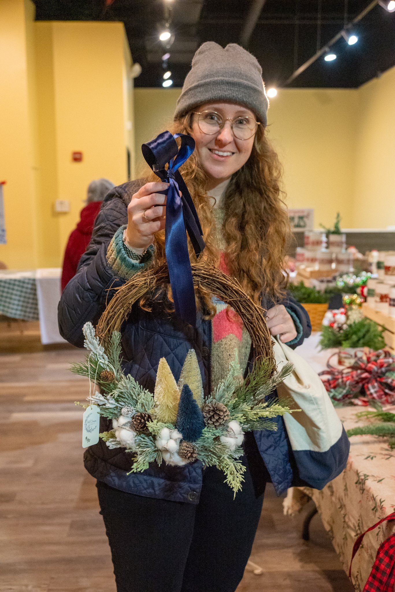 MDP Event Coordinator Magdalena Pawlowski admiring crafts by Rooted Dreams