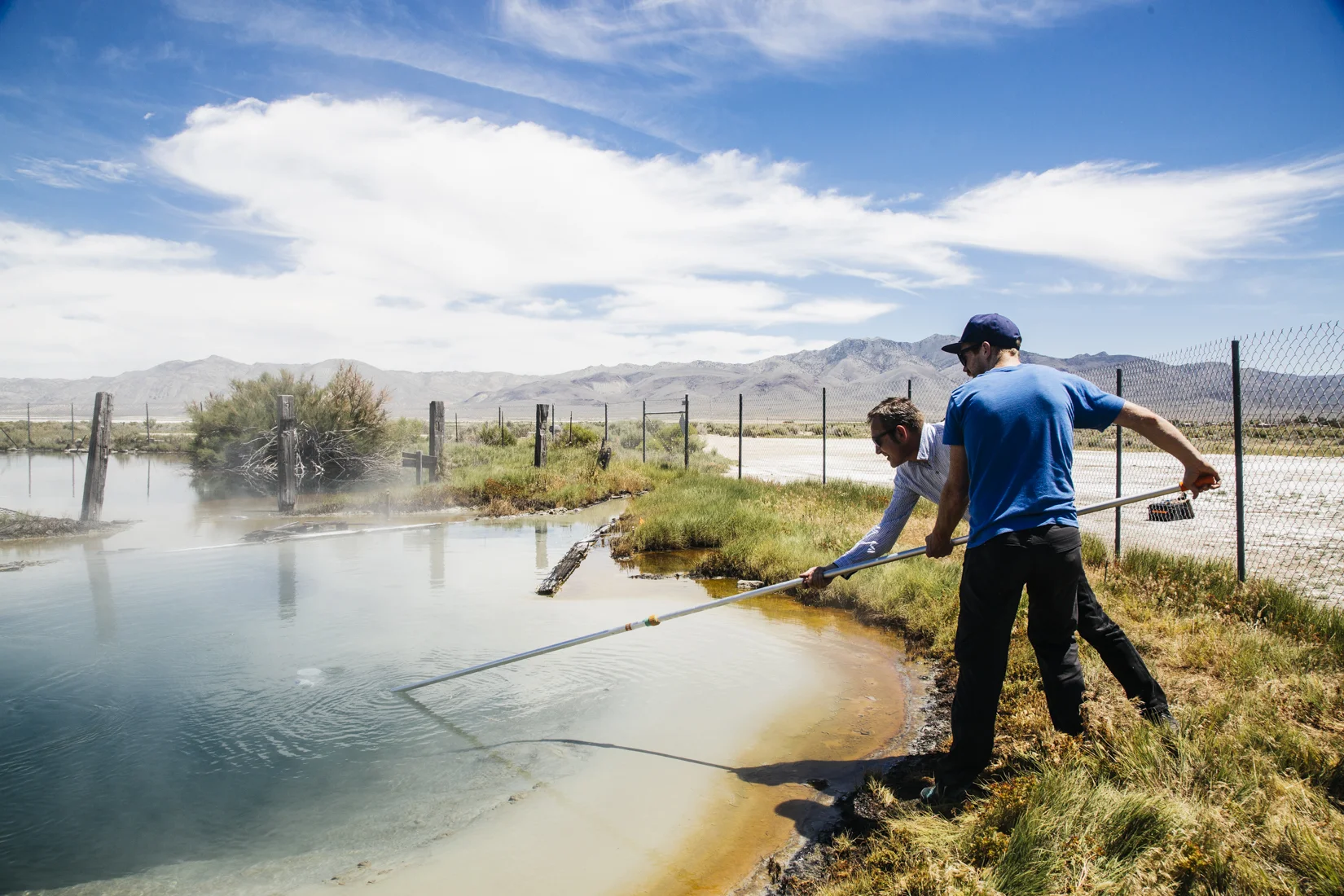 Here I am showing Prof. Axel Cleeremans how we collect gases bubbling up from beneath a hot spring. Not pictured are the 10^658 mosquitos swarming us. (photo cred Michael James Murray )