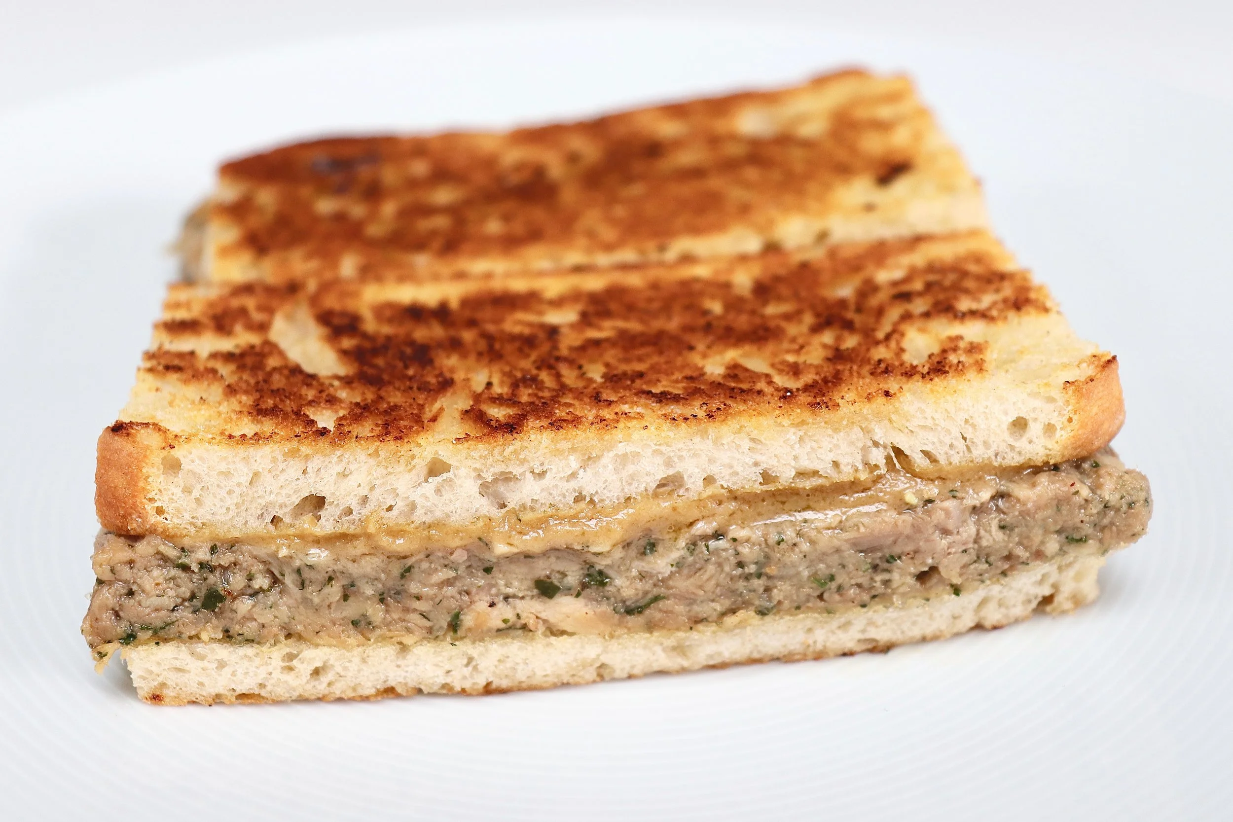 Croque monsieur full of gooey cheese ganache and unctuous ham hock inside golden toasted bloomer