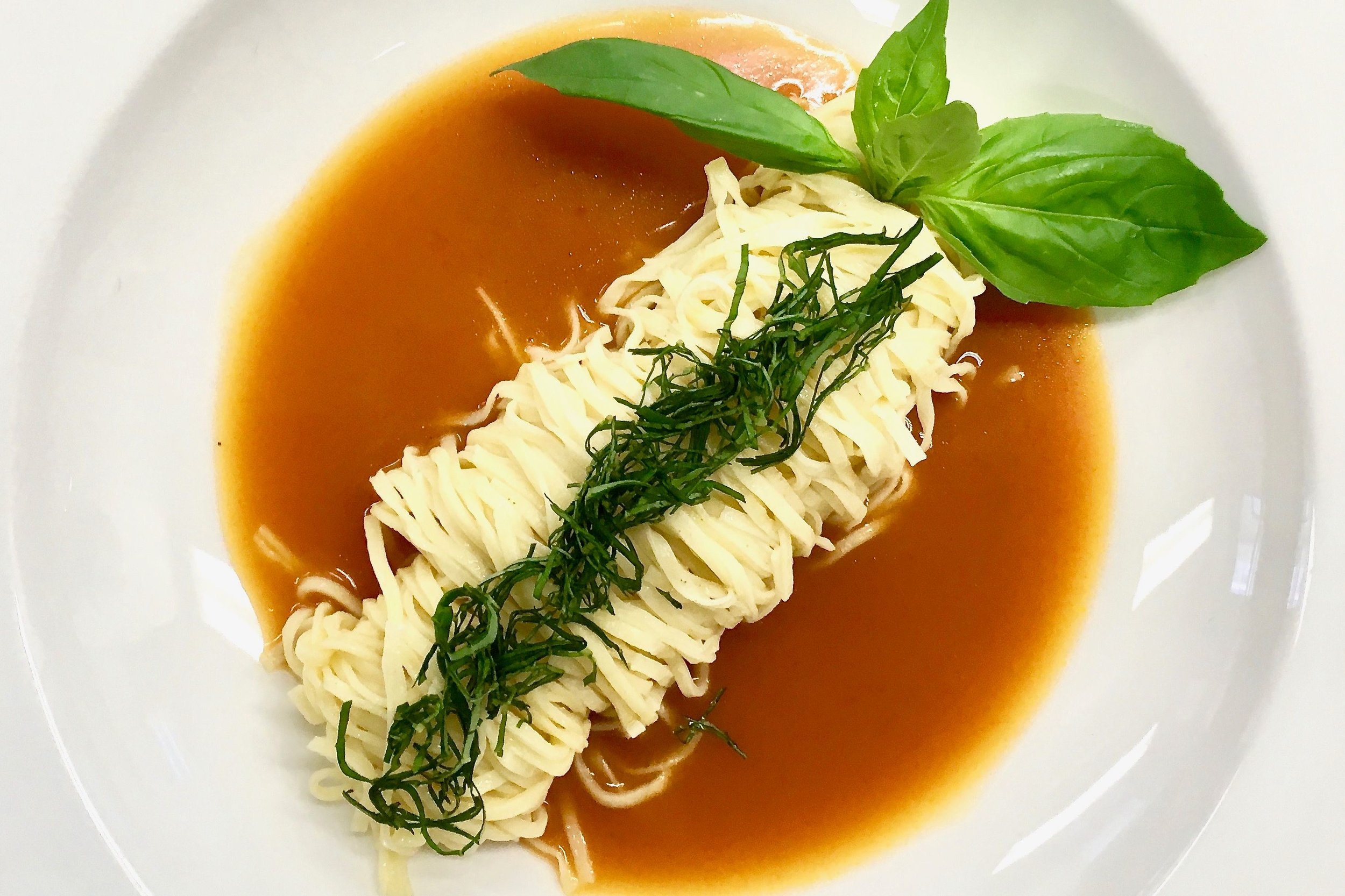 Freshly made pasta with a tomato and basil sauce