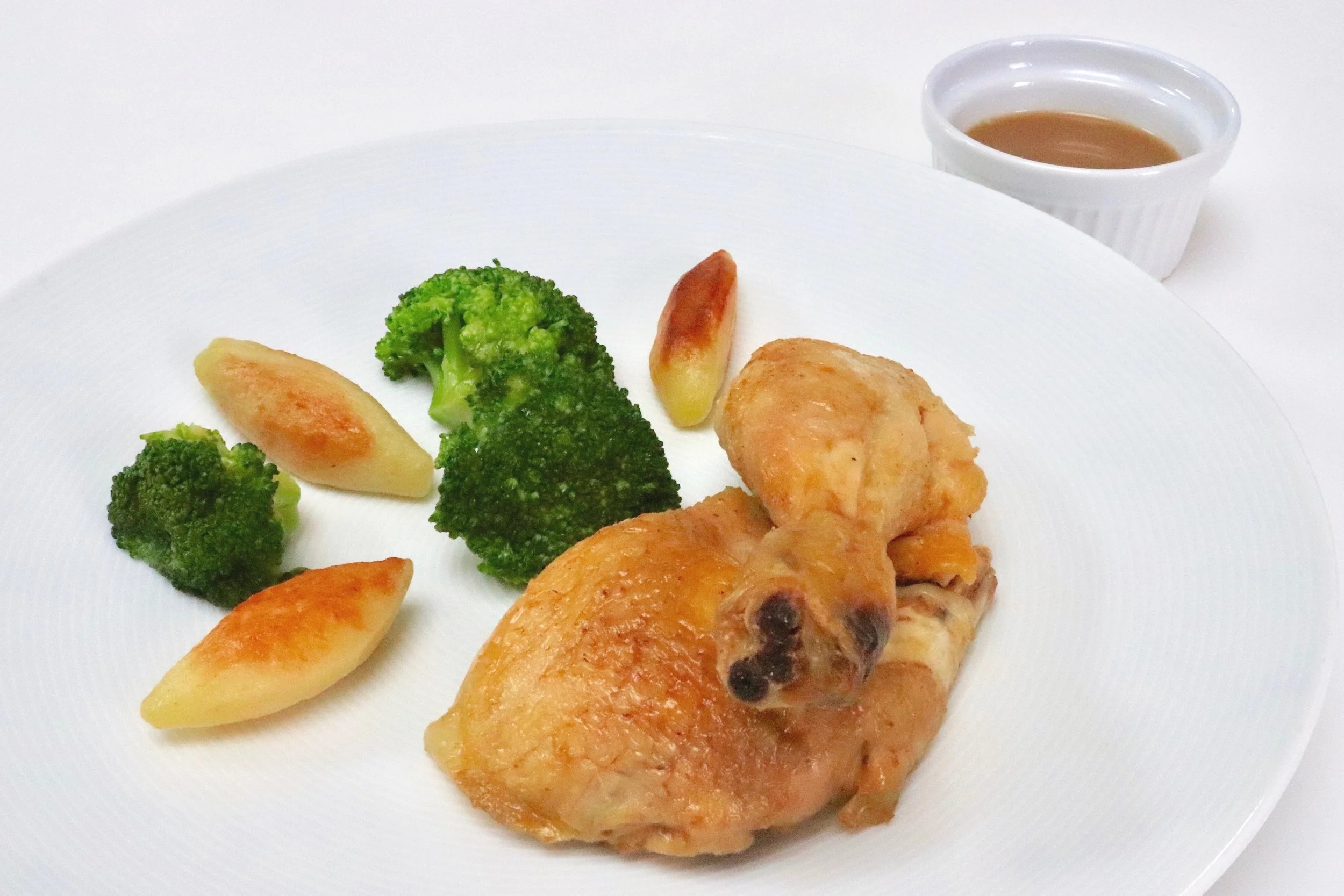 Roast chicken, turned potatoes, broccoli and jus