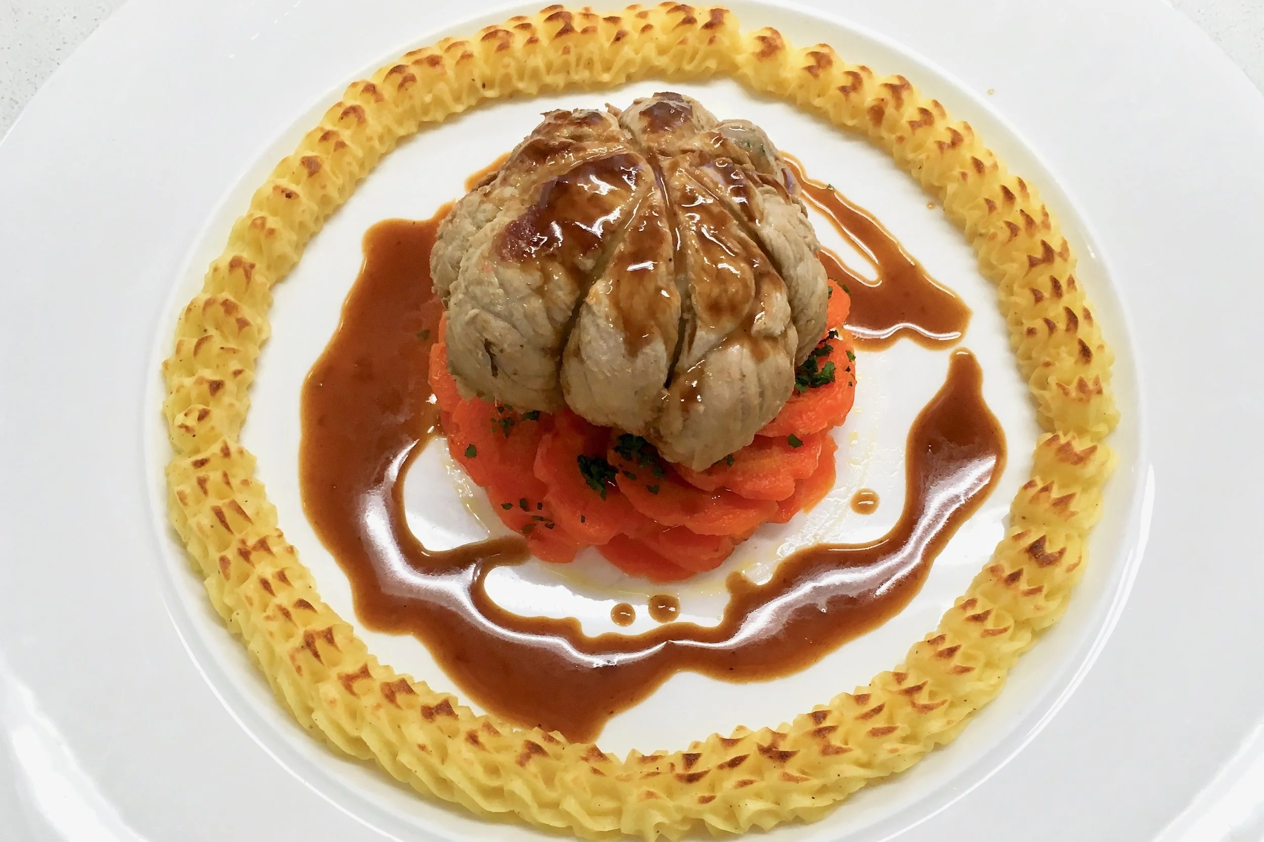 Ball-shaped braised veal parcel with Vichy carrots and potato duchesse
