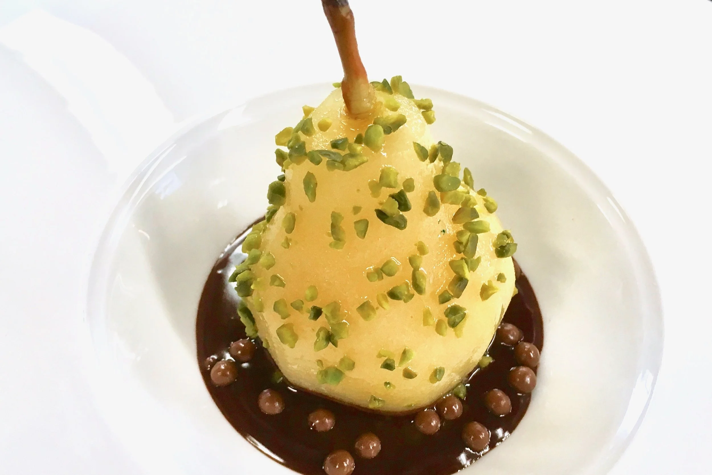 Poached pear with pistachios