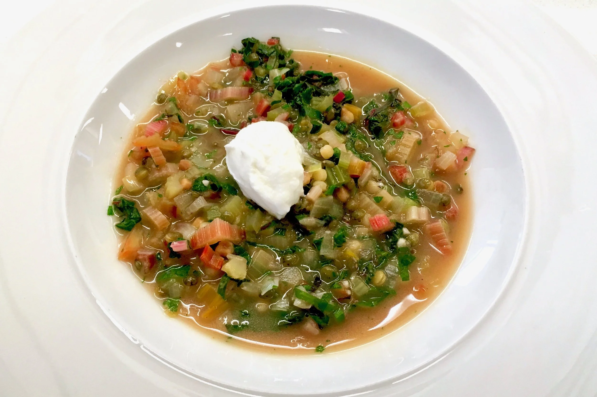 Rainbow chard and lentil soup with fregola and goats curd