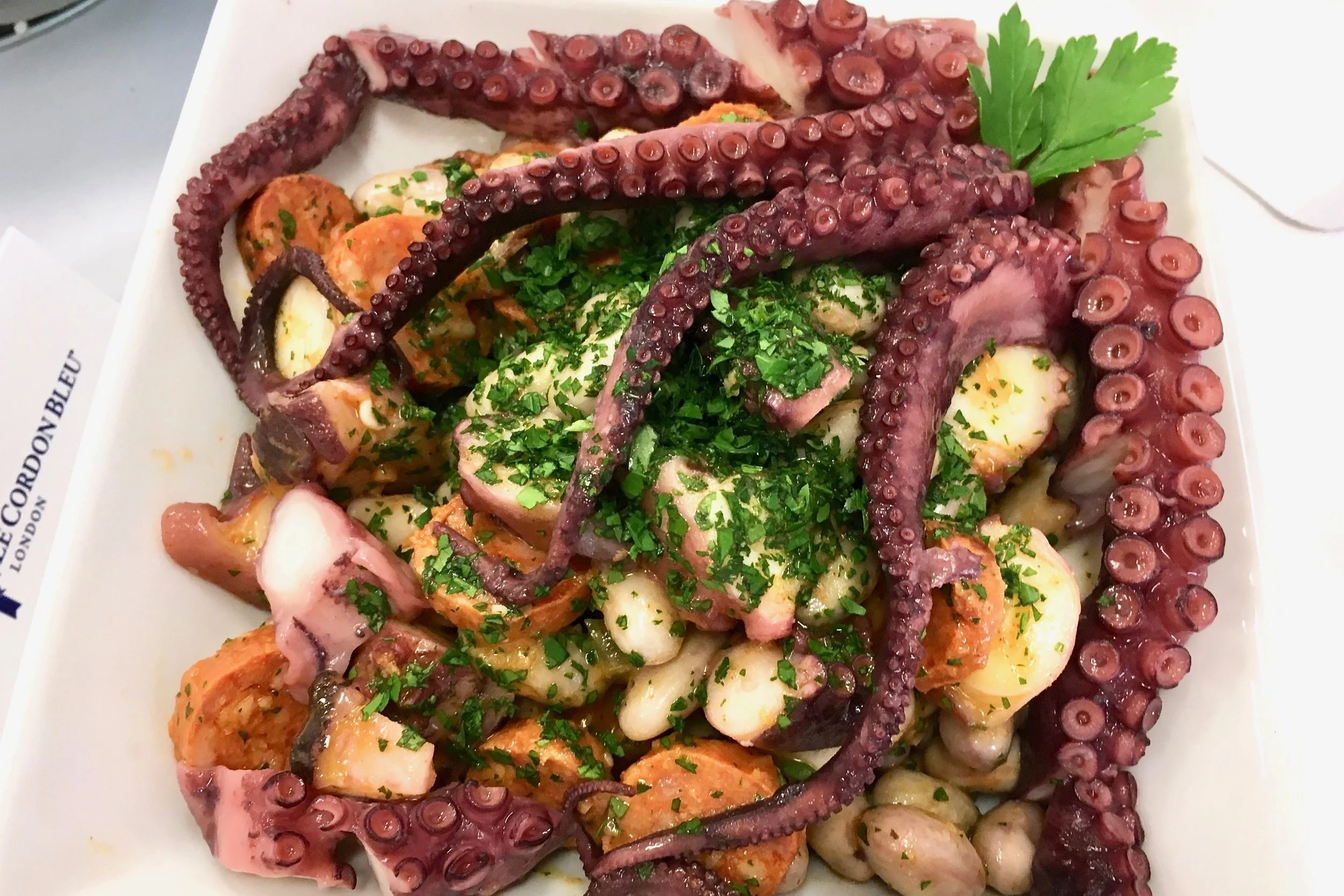 Braised octopus with chorizo, borlotti beans and garlic sauce