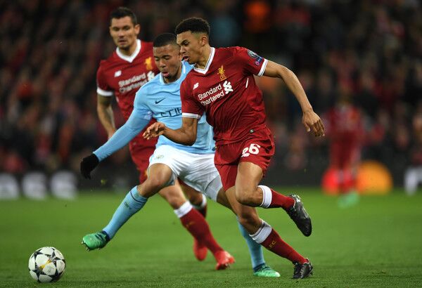 Trent Alexander Arnold dribbles away from Manchester City forward Gabriel Jesus