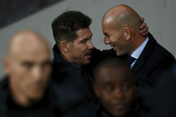 Atletico Madrid coach Diego Simeone embraces Real Madrid coach Zidane ahead of their La Liga fixture.