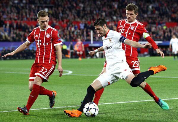 Kimmich and Thomas Muller battle against Sevilla in the UEFA Champions League