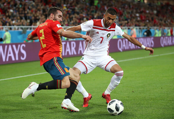 Dani Carvajal of Spain crosses the ball under pressure from Hakim Ziyach of Morocco during the 2018 FIFA World Cup Russia group B match between Spain and Morocco at Kaliningrad Stadium on June 25, 2018 in Kaliningrad, Russia. (June 24, 2018 - Source: Julian Finney/Getty Images Europe) 