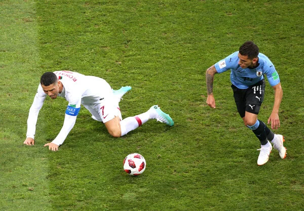 Cristiano Ronaldo of Portugal is challenged by Lucas Torreira of Uruguay during the 2018 FIFA World Cup Russia Round of 16 match between Uruguay and Portugal at Fisht Stadium on June 30, 2018 in Sochi, Russia. (June 29, 2018 - Source: Alex Livesey/Getty Images Europe)