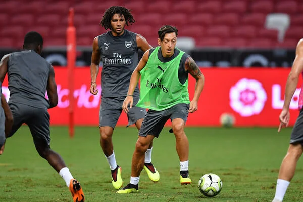 Mesut Ozil #10 and Mohamed Elneny #4 of Arsenal looks on the ball during training ahead of the International Champions Cup 2018 match between Arsenal v Paris Saint Germain on July 27, 2018 in Singapore. (July 26, 2018 - Source: Thananuwat Srirasant/Getty Images AsiaPac)