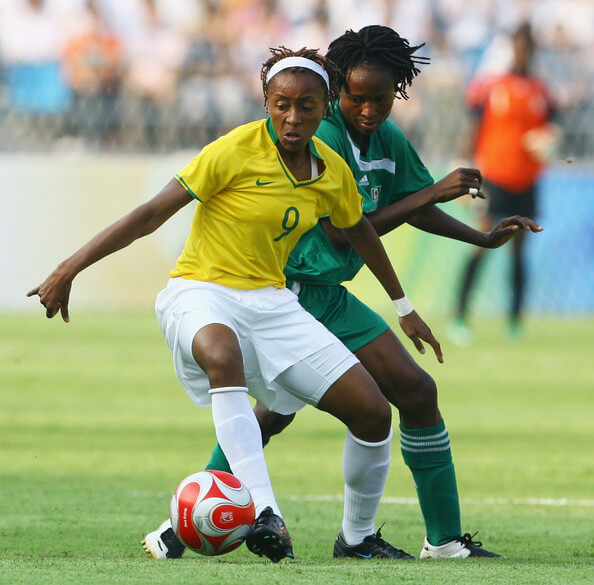 Ester of Brazil holds off Perpetua Nkwocha of Nigeria during the Women's First Round Group F match between Nigeria and Brazil at the Workers' Stadium on Day 4 of the Beijing 2008 Olympic Games on August 12, 2008 in Beijing, China. (Aug. 11, 2008 - Source: Jeff Gross/Getty Images AsiaPac)