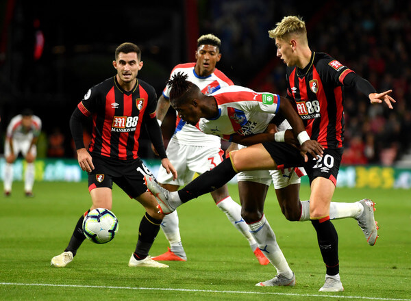 Wilfried Zaha of Crystal Palace battles for possession with David Brooks of AFC Bournemouth during the Premier League match between AFC Bournemouth and Crystal Palace at Vitality Stadium on October 1, 2018 in Bournemouth, United Kingdom. (Sept. 30, 2018 - Source: Mike Hewitt/Getty Images Europe)