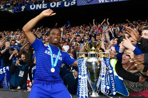 Didier Drogba of Chelsea celebrates with fans and the trophy after the Barclays Premier League match between Chelsea and Sunderland at Stamford Bridge on May 24, 2015 in London, England. Chelsea were crowned Premier League champions. (May 24, 2015 - Source: Mike Hewitt Premier League/Getty Images Europe)