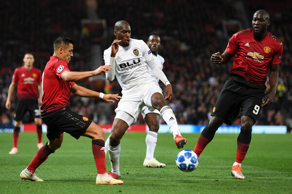 Geoffrey Kondogbia of Valencia is challenged by Alexis Sanchez of Manchester United during the Group H match of the UEFA Champions League between Manchester United and Valencia at Old Trafford on October 2, 2018 in Manchester, United Kingdom. (Oct. 1, 2018 - Source: Michael Regan/Getty Images Europe)