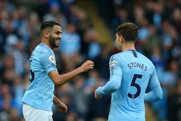 Riyad Mahrez of Manchester City celebrates after scoring his team's fourth goal with John Stones of Manchester City during the Premier League match between Manchester City and Burnley FC at Etihad Stadium on October 20, 2018 in Manchester, United Kingdom. (Oct. 19, 2018 - Source: Alex Livesey/Getty Images Europe)