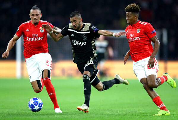 Hakim Ziyech of Ajax is challenged by Ljubomir Fejsa of Benfica (L) and Gedson of Benfica during the Group E match of the UEFA Champions League between Ajax and SL Benfica at Johan Cruyff Arena on October 23, 2018 in Amsterdam, Netherlands. (Oct. 22, 2018 - Source: Dean Mouhtaropoulos/Getty Images Europe)