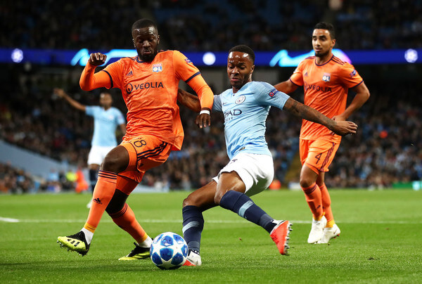 Raheem Sterling of Manchester City shoots while under pressure from Tanguy NDombele Alvaro of Lyon during the Group F match of the UEFA Champions League between Manchester City and Olympique Lyonnais at Etihad Stadium on September 19, 2018 in Manchester, United Kingdom. (Sept. 18, 2018 - Source: Julian Finney/Getty Images Europe)