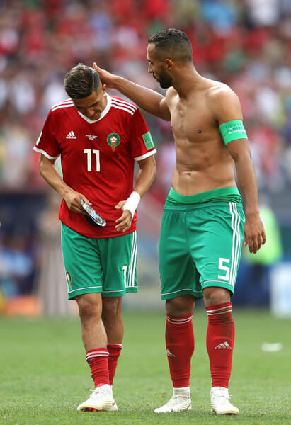 Faycal Fajr (L) of Morocco is consoled by Mehdi Benatia following his sides defeat, meaning his team are knocked out of the World Cup after the 2018 FIFA World Cup Russia group B match between Portugal and Morocco at Luzhniki Stadium on June 20, 2018 in Moscow, Russia. (June 19, 2018 - Source: Michael Steele/Getty Images Europe