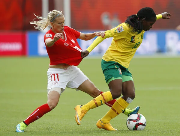 Lara Dickenmann #11 of Switzerland and Claudine Meffometou Tcheno #12 of Cameroon battle for the ball during the FIFA Women's World Cup Canada Group C match between Switzerland and Cameroon at Commonwealth Stadium on June 16, 2015 in Edmonton, Alberta, Canada. (June 15, 2015 - Source: Todd Korol/Getty Images North America)