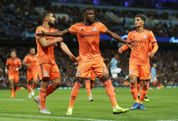 Maxwell Cornet of Lyon celebrates after scoring his team's first goal with his team mates during the Group F match of the UEFA Champions League between Manchester City and Olympique Lyonnais at Etihad Stadium on September 19, 2018 in Manchester, United Kingdom. (Sept. 18, 2018 - Source: Richard Heathcote/Getty Images Europe)