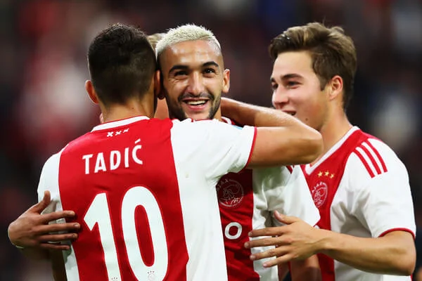Dusan Tadic of Ajax celebrates scoring a goal with Hakim Ziyech during the Eredivisie match between Ajax and Emmen at Johan Cruyff Arena on August 25, 2018 in Amsterdam, Netherlands. (Aug. 24, 2018 - Source: Dean Mouhtaropoulos/Getty Images Europe)
