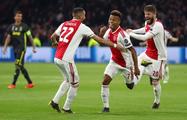 David Neres of Ajax celebrates with teammates after scoring his team's first goal during the UEFA Champions League Quarter Final first leg match between Ajax and Juventus at Johan Cruyff Arena on April 10, 2019 in Amsterdam, Netherlands. (April 9, 2019 - Source: Getty Images Europe)