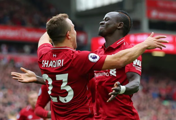 Xherdan Shaqiri of Liverpool celebrates with teammte Sadio Mane after he provides the assist for Liverpool's first goal, an own goal by Wesley Hoedt of Southampton during the Premier League match between Liverpool FC and Southampton FC at Anfield on September 22, 2018 in Liverpool, United Kingdom. (Sept. 21, 2018 - Source: Alex Livesey/Getty Images Europe)
