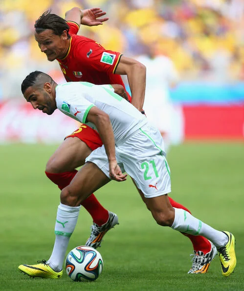 Riyad Mahrez of Algeria holds off a challenge by Daniel Van Buyten of Belgium during the 2014 FIFA World Cup Brazil Group H match between Belgium and Algeria at Estadio Mineirao on June 17, 2014 in Belo Horizonte, Brazil. (June 16, 2014 - Source: Jeff Gross/Getty Images South America)