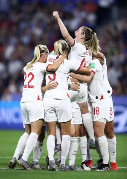 Lucy Bronze of England celebrates with teammates after scoring her team's third goal during the 2019 FIFA Women's World Cup France Quarter Final match between Norway and England at Stade Oceane on June 27, 2019 in Le Havre, France. (June 26, 2019 - Source: Getty Images Europe)
